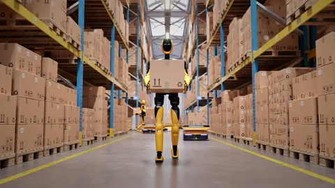 Humanoid robot worker walking with cardboard box in automated warehouse Stock Footage 329510541