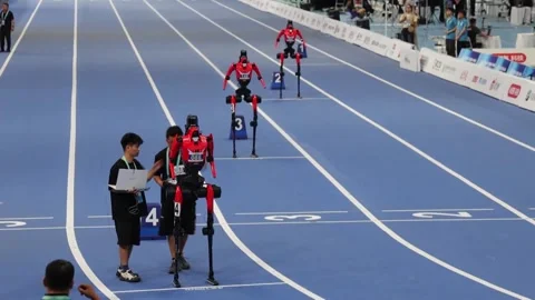 Humanoid robots race in 400-meter event at World Humanoid Robot Games in Beijing Stock Footage 343254174