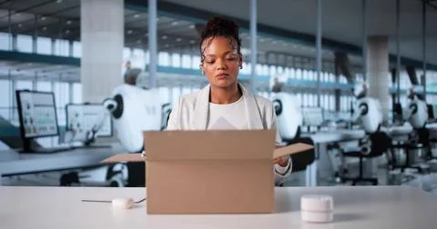 Humanoid Robots Taking Over: Unemployed Woman Packing Belongings In Office Stock Photos