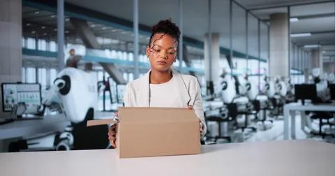 Humanoid Robots Taking Over: Unemployed Woman Packing Belongings Stock Photos