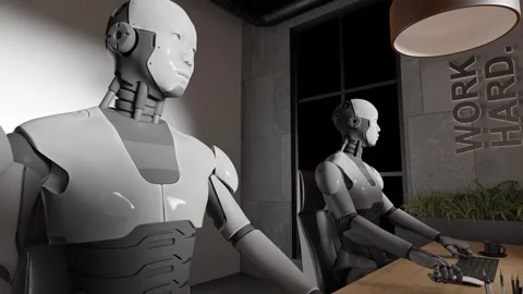 Humanoid robots working at desks with computers in modern office interior with Stock Footage 312027644