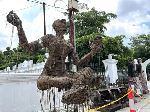 A humanoid statue made from threads in a float pose. Stock Photos