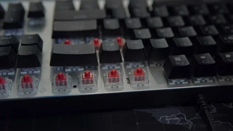 A human's hand assembles the keys of a mechanical keyboard with red switches Stock Footage 194561495