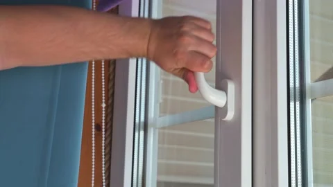 Humans hand closing the window. 4k video in slow motion Stock Footage 204895277