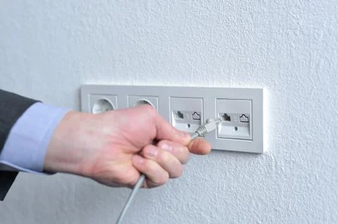 Humans hand with network cable Stock Photos