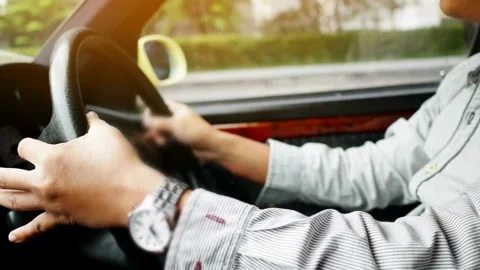 Human's hands on the steering wheel, inside the car. Taken in close-up, in the Video stock 336266178