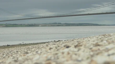 The Humber Bridge On A Pebble Beach. Vídeos de archivo 107481131