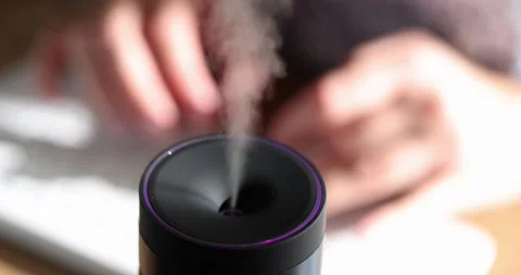Humidifier with aroma oil diffuser on table closeup Video stock 232622199