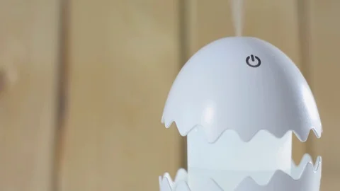 Humidifier on a white table on a wooden background. Stock Footage 122804873
