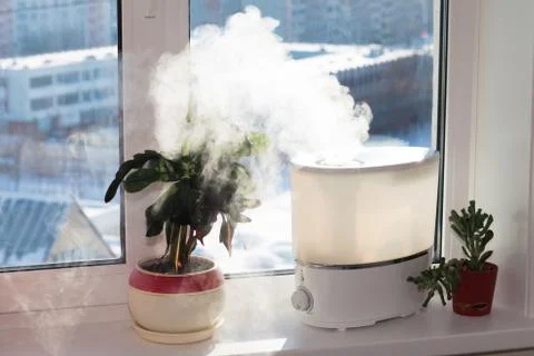 Humidifier on window Stock Photos