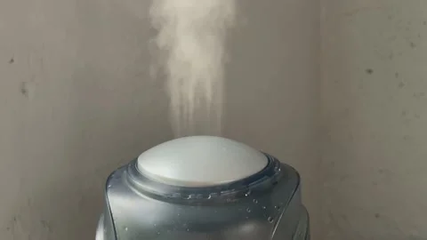 Humidifier works on the grey wall backgound. Water mist steam from humidifier Stock Footage 170786814