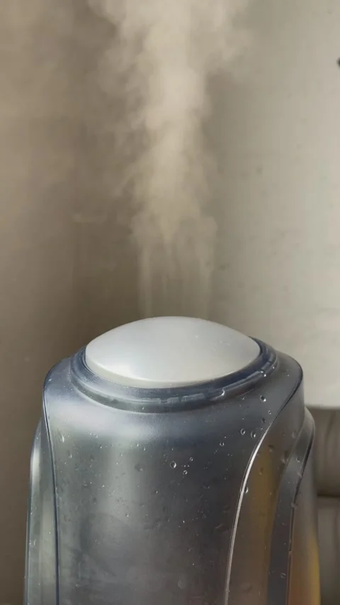 Humidifier works on the grey wall backgound. Water mist steam from humidifier. Stock Footage 170858205