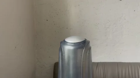 Humidifier works from low to high power on the grey wall backgound. Water mist Stock Footage