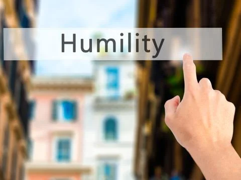Humility - Hand pressing a button on blurred background concept . Business, t Stock Photos