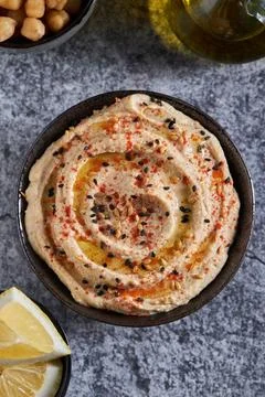 Hummus and lemon on marble table Stock Photos