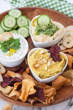 Hummus and vegetable chips Stock Photos
