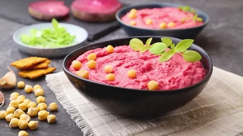 Hummus with beet  in blue ceramic bowl sprinkle with sesame seeds. Stock Footage 127058832