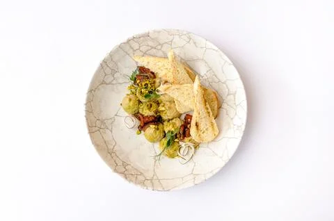 Hummus with croutons on a white background Stock Photos