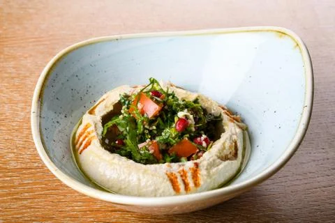 Hummus is a dip, spread, mashed chickpeas blended with tahini, lemon juice, a Foto stock