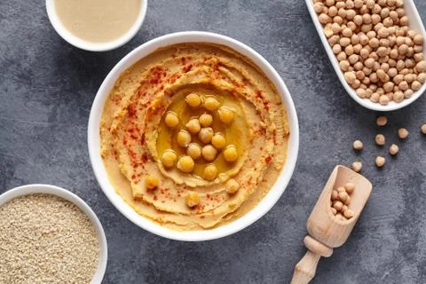 Hummus homemade middle eastern arab dip paste flat lay with paprika, tahini Stock Photos