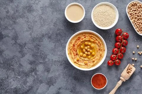 Hummus homemade middle eastern dip paste flat lay with paprika, tahini, sesame Stock Photos