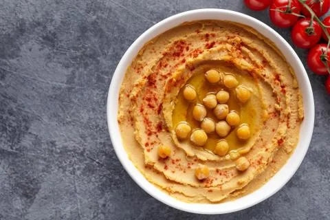 Hummus homemade middle eastern dip paste close up with paprika, tahini, sesame Stock Photos