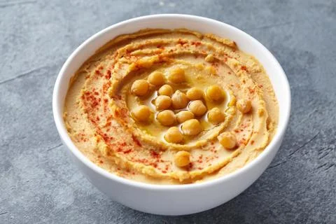 Hummus homemade middle eastern dip paste close up with paprika, tahini, and Stock Photos