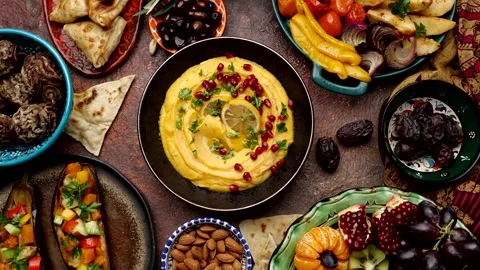 Hummus is a Middle Eastern savory dish made from cooked, mashed chickpeas Stock Footage 235750132