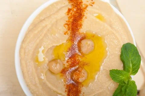 Hummus with mint on top Stock Photos