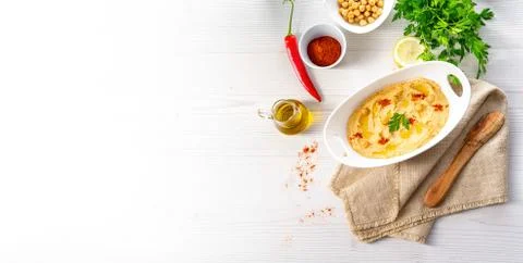 Hummus paste with lemon and chilli on white background Stock Photos