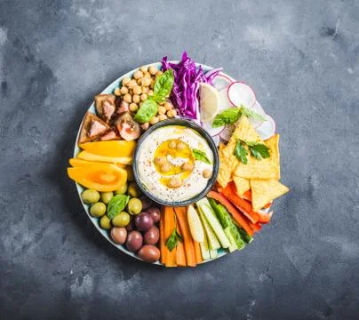 Hummus platter with assorted snacks Stock Photos