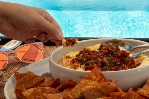 Hummus by the pool. Stock Photos