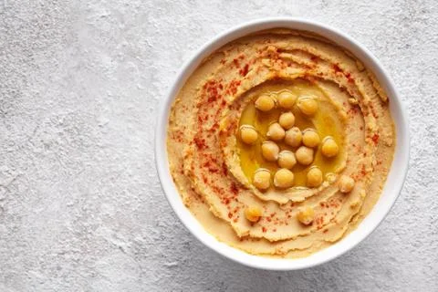 Hummus traditional middle eastern dip paste close up with paprika, tahini, and Stock Photos