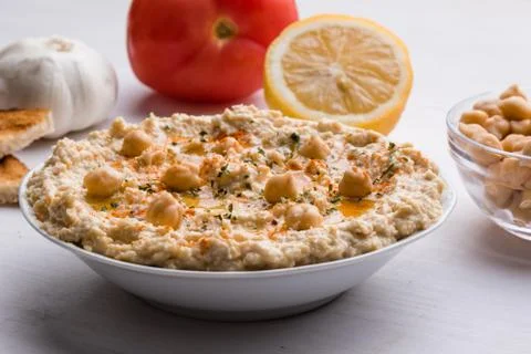 Hummus on white table Stock Photos