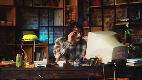 Humorous nerdy guy typing on keyboard, reading shocking news, 90s lifestyle 스톡 동영상 321072152