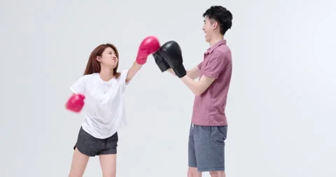 Humorous young Chinese couple practicing boxing,4K Видео 246745430