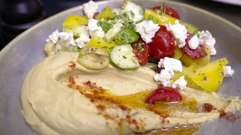 Humus plate with white cheese and vegetables Stock Footage 247400904