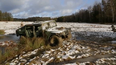 Humvee being pulled out from a creek Stock Footage 110795605