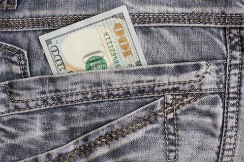 Hundred dollar bill inside back pocket jeans Stock Photos
