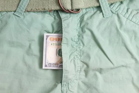 Hundred dollar bill inside  codpiece green pants Stock Photos