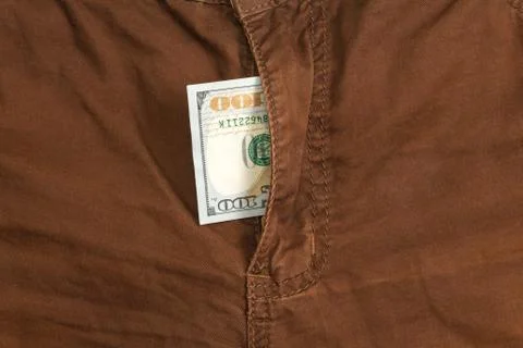 Hundred dollar bill inside  codpiece brown jeans Stock Photos