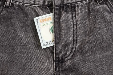Hundred dollar bill inside  codpiece gray jeans Stock Photos