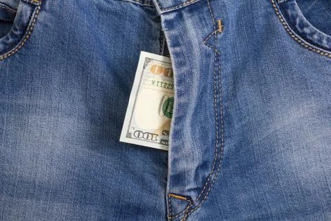 Hundred dollar bill inside  codpiece blue jeans Stock Photos