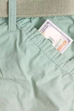 Hundred dollar bill inside front pocket pants Stock Photos