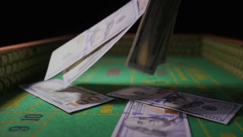 Hundred dollar bills falling on craps table slow motion Stock Footage 153952628