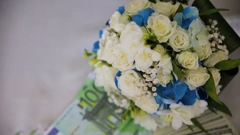Hundred dollar bills spinning on a table with flowers. Stock Footage 95634649