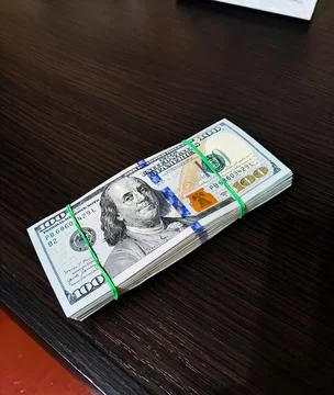 Hundred dollar bills on the table. Stack of money in dollars. Cash check in.. Stock Photos