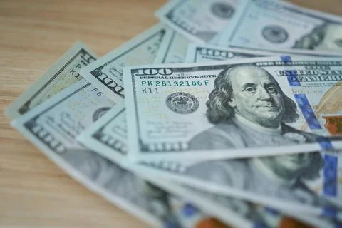 Hundred dollar notes are lying on the table. Stock Photos
