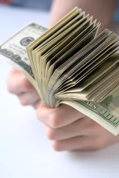 Hundred dollars in hand Stock Photos
