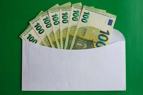 Hundred euro bills in an envelope on a green background, financial payments,  Stock Photos